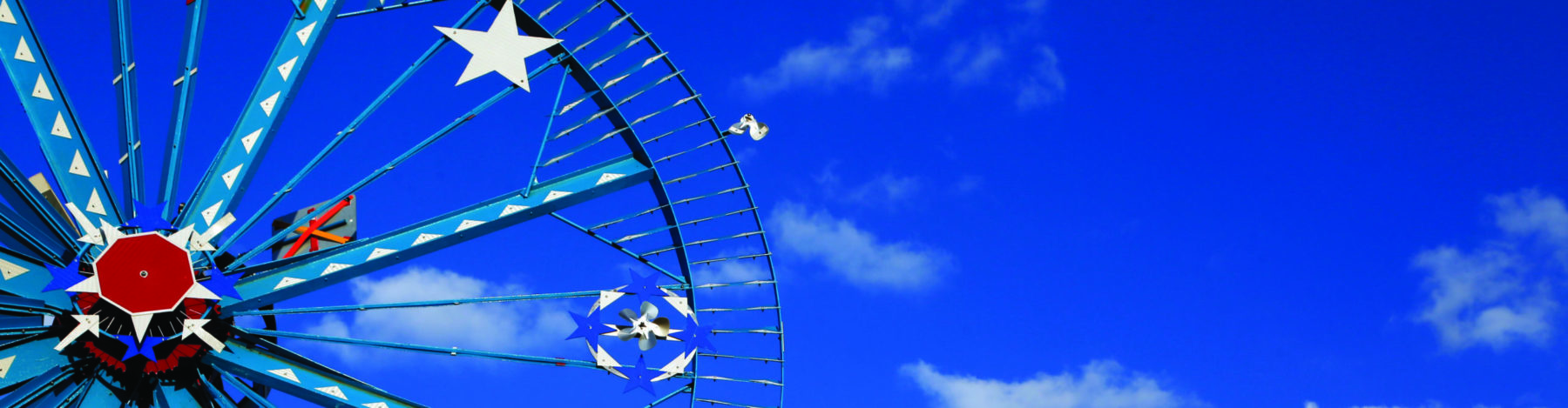 Part of Whirligig pictured next to blue sky and white clouds - Discover Wilson