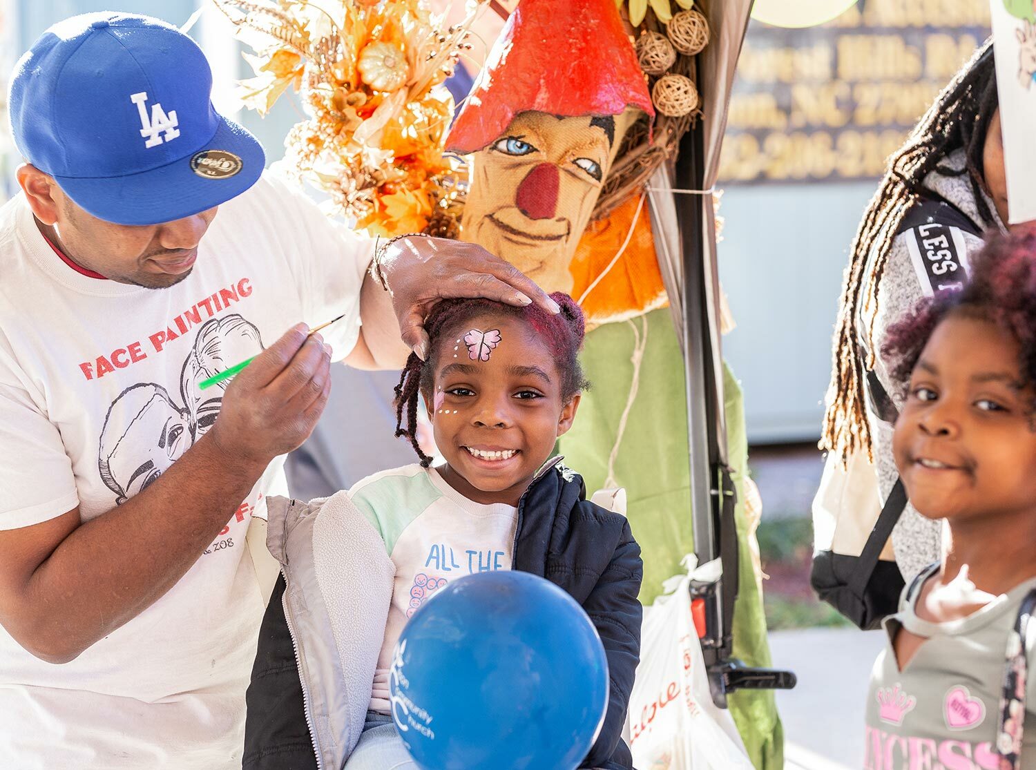 Girl smiling while having her face painted at an event in Wilson, NC - Discover Wilson