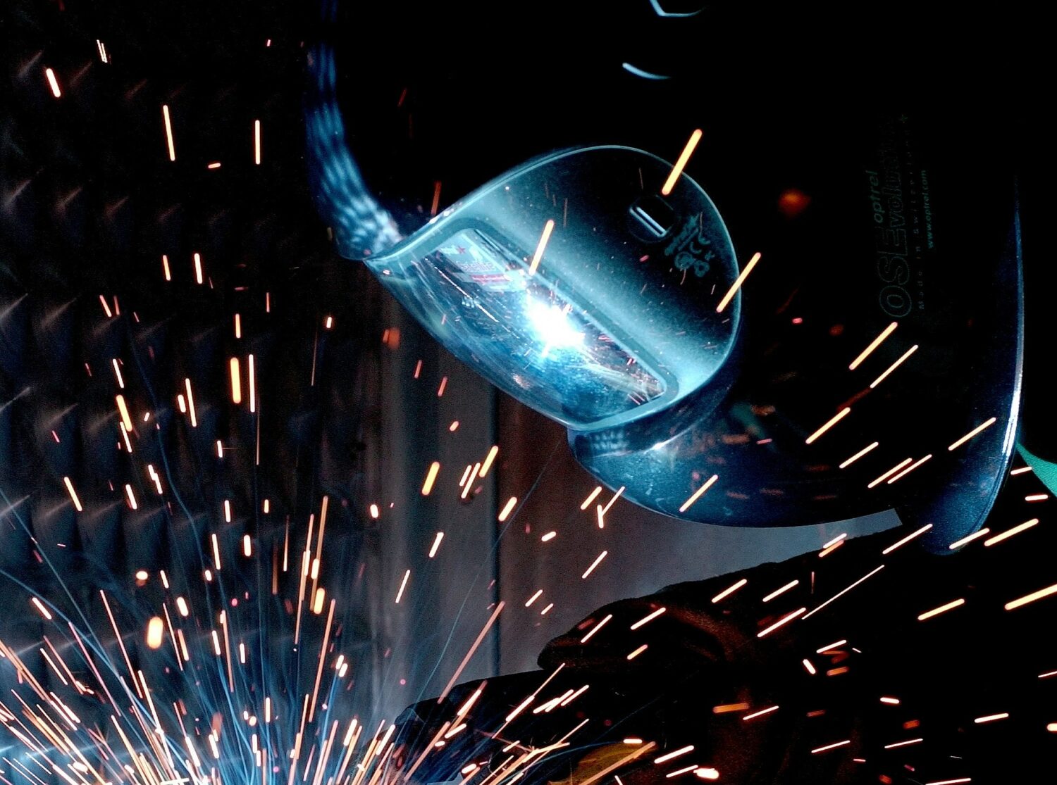 Person working a manufacturing job, with sparks bursting upwards - Discover Wilson